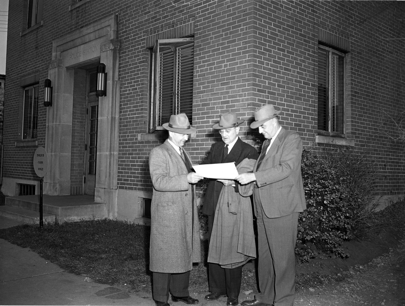 Officials check plans in front of P.D.